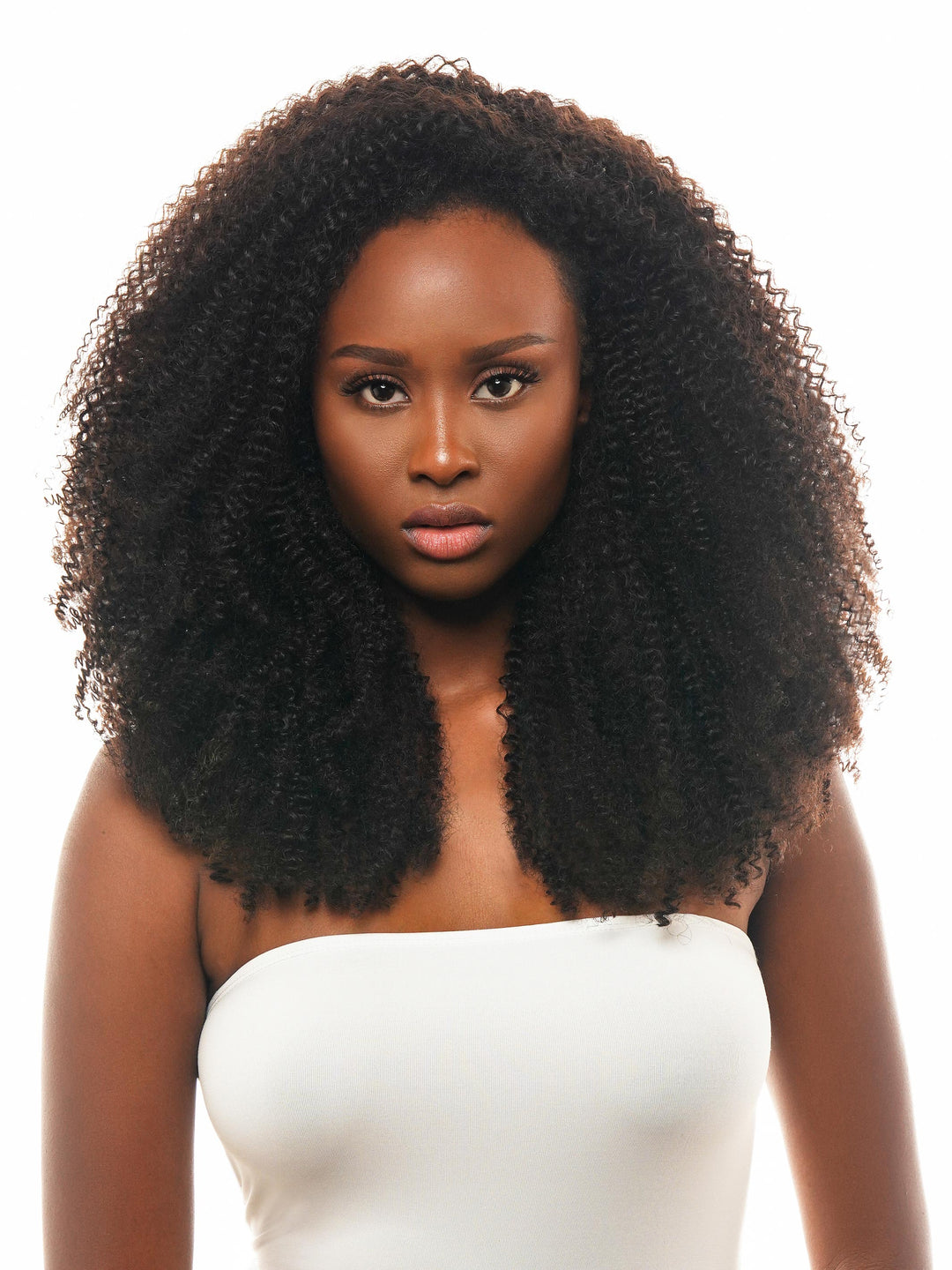 Close-up image of Claudene's Bella Cheveux's Serene Kinky Curly Virgin Hair Bundles, showcasing the intricate 3c/4a natural curl patterns. The bundles exude a vibrant, natural look, emphasizing their thick, full-bodied texture and the versatility they offer for creating numerous styles, available in lengths from 14" to 30"