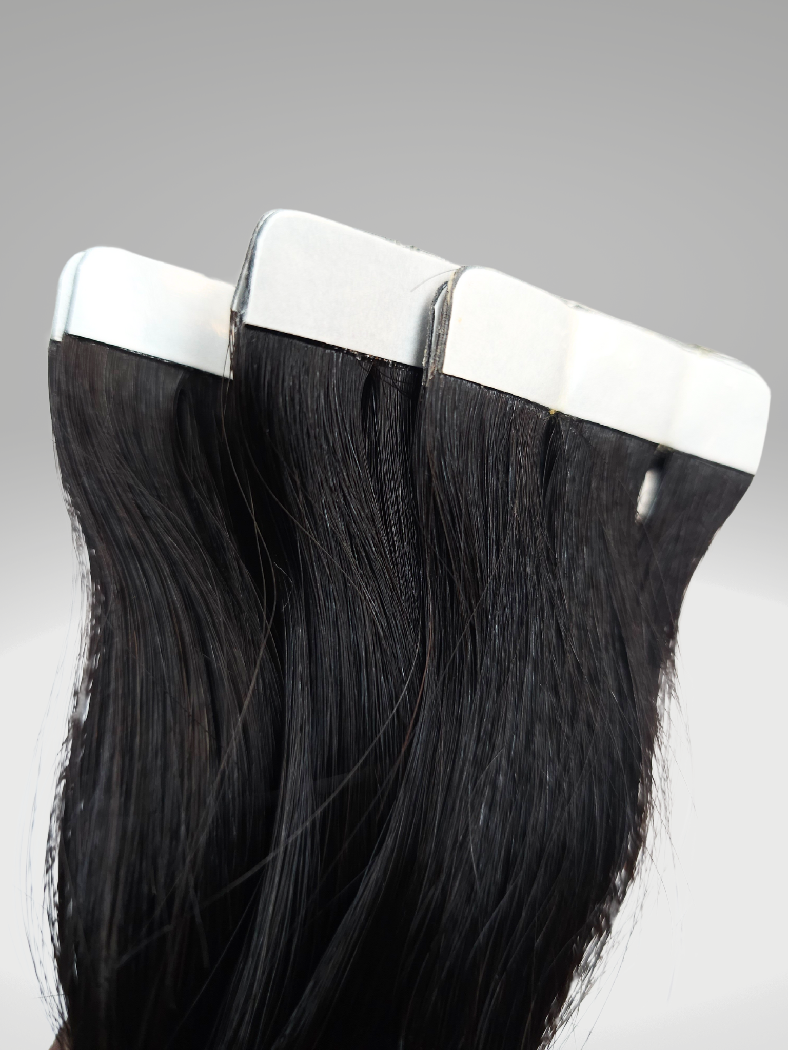 "High-quality Devine Body Wave Tape-in Hair Extensions in various lengths from 16 to 30 inches, showcasing natural wave patterns. Perfect for versatile styling and coloring to match personal fashion preferences.